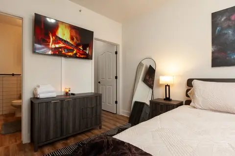 Cozy Primary Bedroom with King size bed, TV, nightstands, full-length mirror, dresser at Pheasant Run Condo, Coeur d'Alene Idaho