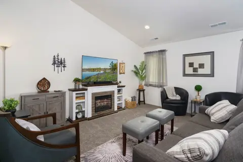 Gather the whole family in this cozy living room—sink into the plush sectional under soft at Pine and Vine Cottage, Rathdrum Idaho