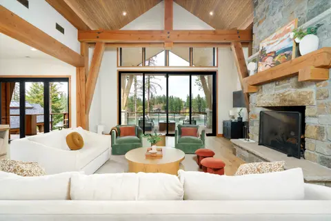 Bright and airy great room with vaulted ceilings, cozy seating, a stone fireplace at River Camp Lodge, Coeur d'Alene Idaho