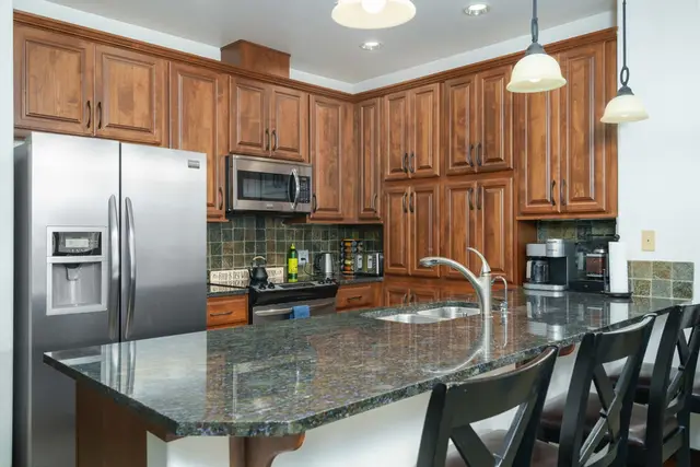 Warm wood cabinetry and generous counter space welcome relaxed cooking at home at Riverstone Village Retreat, Coeur d'Alene Idaho