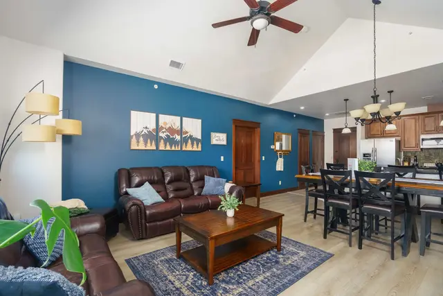Leather seating and mountain artwork make the living room an inviting place to relax at Riverstone Village Retreat, Coeur d'Alene Idaho