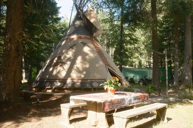 Tipi entrance with dappled forest light at Woodland Tipi, Sandpoint Idaho