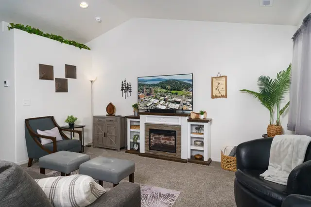 A stocked board game cabinet turns this welcoming living room into game-night at Pine and Vine Cottage, Rathdrum Idaho