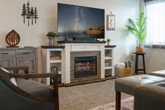 Cozy up by the stone fireplace on cool evenings—a warm, inviting corner for hot cocoa at Pine and Vine Cottage, Rathdrum Idaho