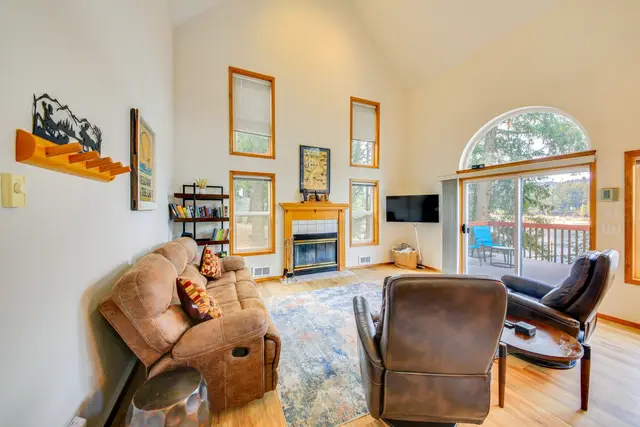 Main level living room with comfy sofa and chairs for enjoying the views at Bay-View Cabin, Bayview Idaho